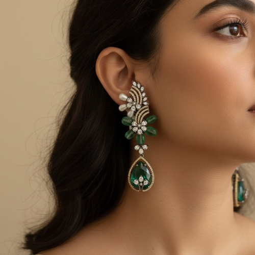 Elegant green crystal drop earrings with floral and pearl accents.”