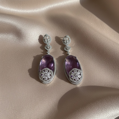 Elegant earrings with faceted purple oval stones and floral crystal detailing